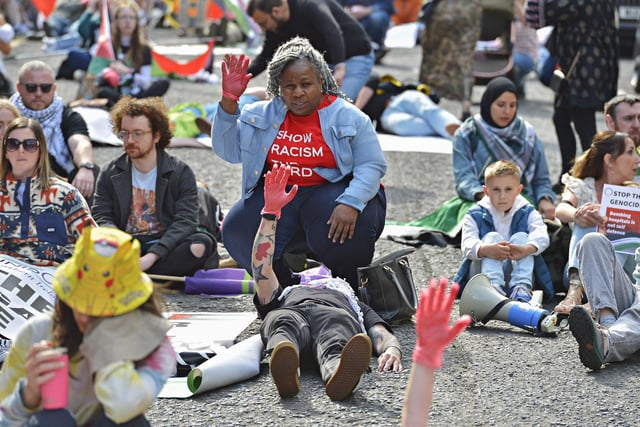 People taking part in a Freedom for Palestine march and rally “lay dead” on Shipquay Street, on Saturday afternoon, highlighting the number of Palestinians who have been killed by Israel.  Photo: George Sweeney