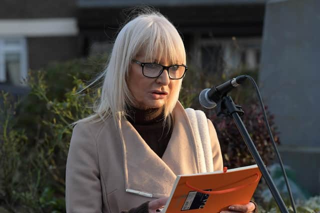 Ciara Devlin reads a poem written by her son Eoghan McKinney at the Bloody Sunday monument, at Joseph’s Place on Tuesday afternoon, where a one minute silence was observed on the 52nd anniversary of the Bloody Sunday massacre. Photo: George Sweeney.