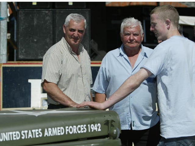 Bernard Doherry, Jim Morrission (owner) and Stephen Doherty discuss some of the vintage vehicles on show at the vintage Rally in Clonmany.  (0908JB33) : Clonmany Festival, Vintage Show, Agricultural Show and Raft Race in August 2005.