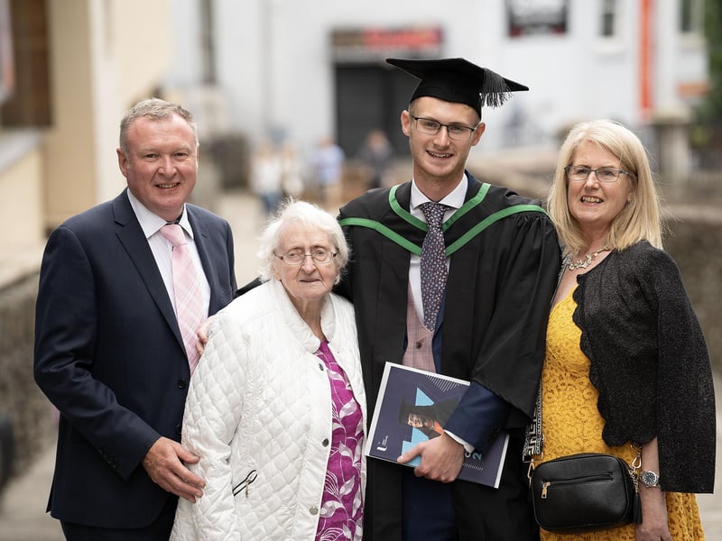 James Weir celebrates with mum Gillian Weir (right), dad George Weir (left), and granny Mildred Weir as he graduates with a degree in Information Technology from Ulster University in Derry on Monday July 8. (Photo: Nigel McDowell / Ulster University)