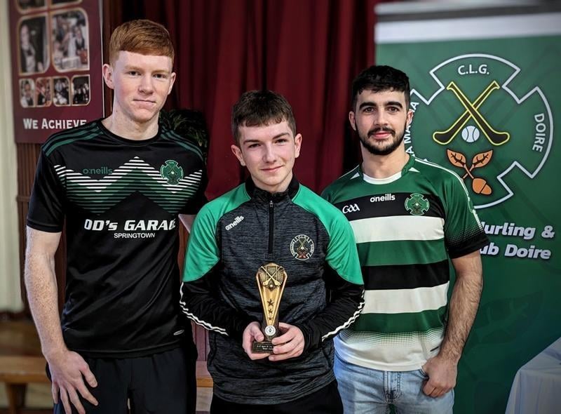 Daniel Doherty and Keelan Doherty present the U17 Hurlers Spirit of the Team award to Shane Campbell.