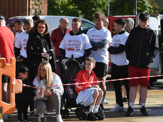 Fundraising teams members who took part in the pulling of a 32-tonne City of Derry Airport Fire and Rescue Engine, in Guildhall Square, in aid of Children In Crossfire. Photo: George Sweeney