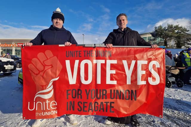 People Before Profit Councillor Shaun Harkin, on right, behind a Seagate union recognition banner at the recent public sector strike march.
