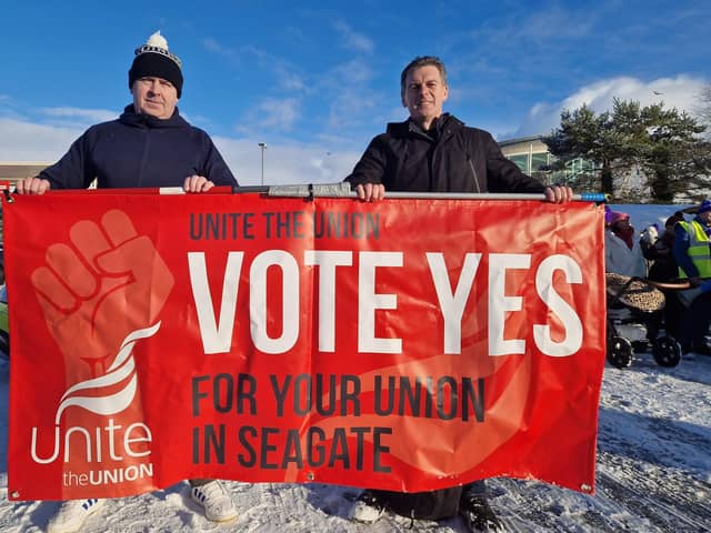 People Before Profit Councillor Shaun Harkin, on right, behind a Seagate union recognition banner at the recent public sector strike march.