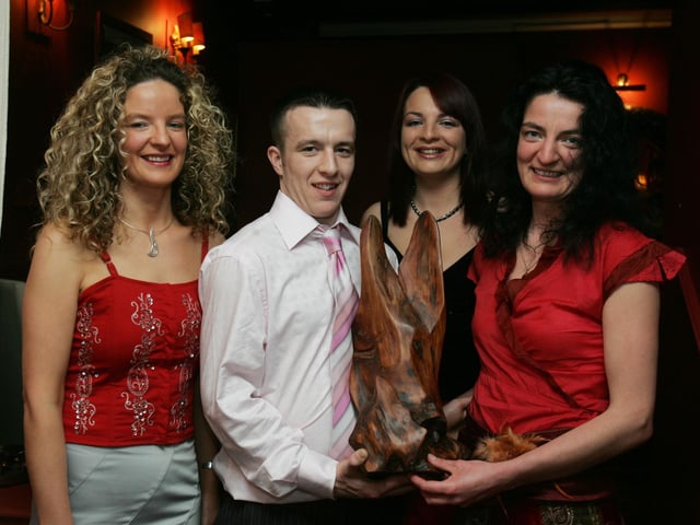 Sisters Denise, Rosarie and Mary-Anthony presenting the Seamus McCloskey Memorial Award to Paddy McColgan. (2102C48) : Malin GAA Dinner