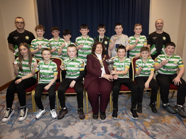 The Mayor, Patricia Logue, pictured at the D&D Youth FA Annual Awards at the City Hotel on Friday night presents Top of the Hill Celtic U12s with the League Trophy. Included are coaches Martin Doherty and Aidan Wilson.