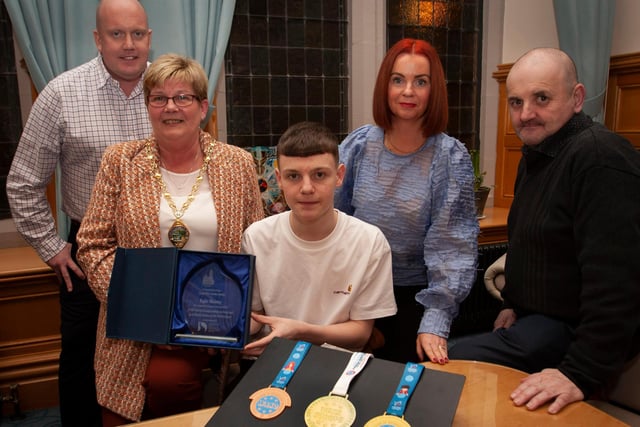 WELL DONE KYLE!. . . .The Deputy Mayor of Derry City and Strabane District Council, Angela Dobbins making a special presentation to Derry teenager Kyle Moore in recognition of his recent success in the WAKO World Championships in Italy and his gold medal success at the Bristol Open, during a reception in his honour at the Mayor’s Parlour, Guildhall on Thursday night last. Included are Kyle’s parents Paul and Shauna and his coach Gary Kelly.