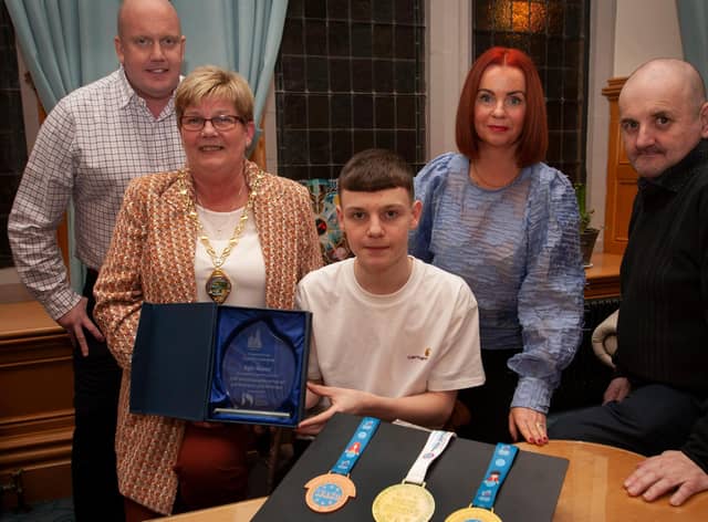 WELL DONE KYLE!. . . .The Deputy Mayor of Derry City and Strabane District Council, Angela Dobbins making a special presentation to Derry teenager Kyle Moore in recognition of his recent success in the WAKO World Championships in Italy and his gold medal success at the Bristol Open, during a reception in his honour at the Mayor’s Parlour, Guildhall on Thursday night last. Included are Kyle’s parents Paul and Shauna and his coach Gary Kelly.