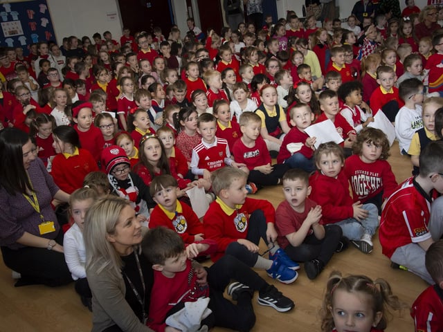 Pupils and staff listen to Derry City players Shane and Patrick McEleney and Michael Duffy during their visit on Tuesday. (Photo: Jim McCafferty)
