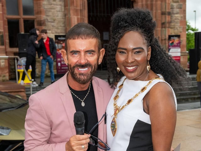 Compere Michael Doherty with Derry City and Strabane District Council Mayor, Councillor Lilian Seenoi-Barr as she hosted Supercar Saturday in Guildhall Square to raise money for the Mayoral Charity Bud Club. The event attracted car enthusiasts and owners from across the region to support aid the local charity. Picture Martin McKeown. 24.05.25