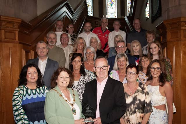 The Mayor of Derry City and Strabane District Council Patricia Logue makes a presentation to Eddie Breslin, in recognition of his retirement from the Housing Executive and his contribution to housing in the city and district, at a special function in the Guildhall on Thursday evening. Included are family, friends and former work colleagues. (Photos: JIm McCafferty Photography)