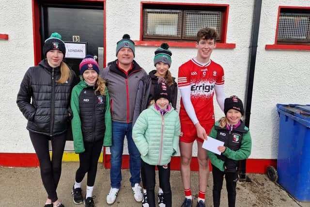 Dermot Friel (third from left) of Friel's Bar, Swatragh present Derry midfielder Ruairi O'Mianain with his 'Man of the Match' award following the Oak Leafers' victory over London in Celtic Park on Sunday.