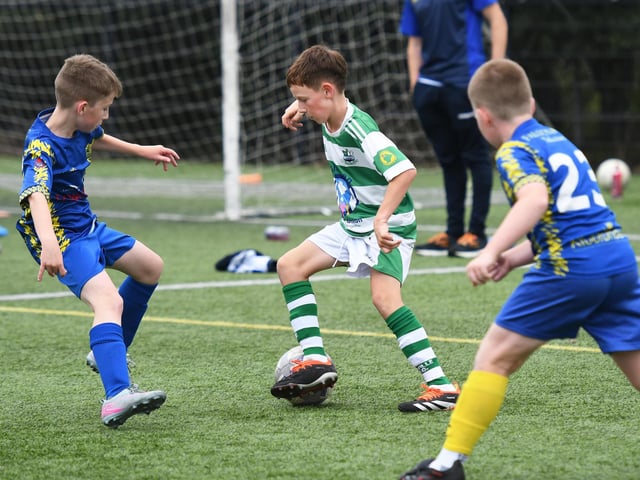 Malachy Gill, Moville Celtic, keeps Dungannon's Jackson Maneely on his toes during the under-11's match at the Vale Centre.