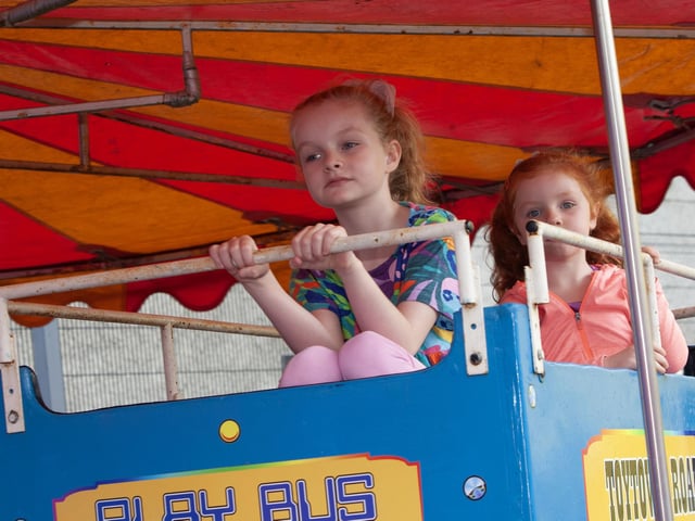 Sisters Alexandra (8) and Alanna Houston enjoying some of the amusements on Saturday at Féile 23's event in Pilot's Row.
