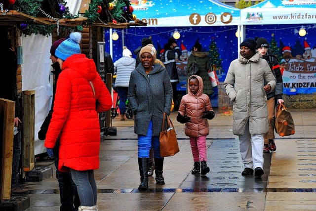 People visiting the Christmas Market in Guildhall Square on Friday afternoon. Photo: George Sweeney. DER2250GS – 63