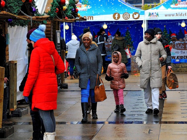 People visiting the Christmas Market in Guildhall Square on Friday afternoon. Photo: George Sweeney. DER2250GS – 63