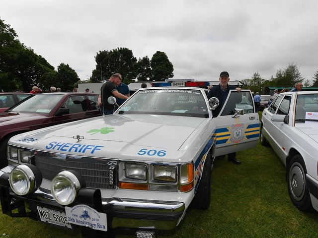 Colm Dillon, right, brought along his classic Ford sheriff’s car to the Muff Vintage Show, held in the Community Park on Sunday. Photo: George Sweeney.