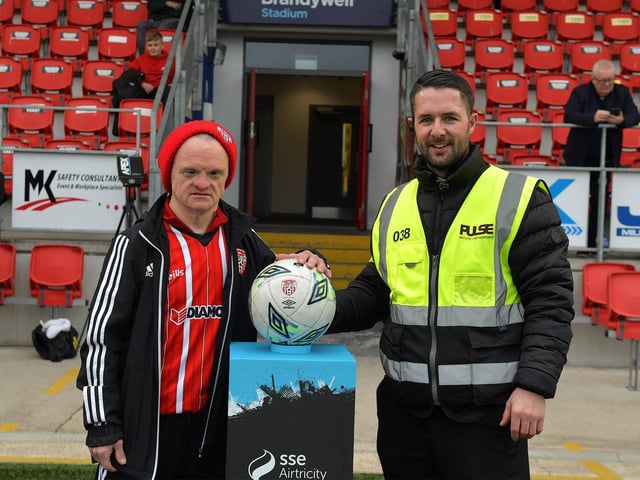John Pio O’Doherty, the candystripes number one fan pictured with Derry City steward Barry Glackin before the game against UCD on Friday evening last. Photo: George Sweeney.  DER2320GS – 128