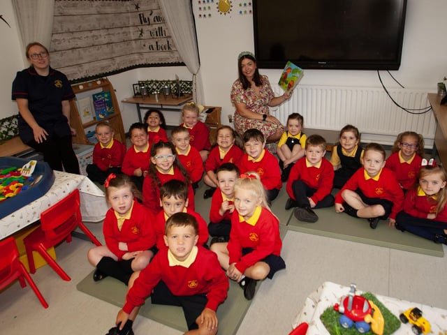 Mrs. Neidin Kelly pictured with her P1 class at Steelstown PS this week. On left is Miss Katie Barnfield, Classroom Assistant. (Photos: Jim McCafferty Photography):.