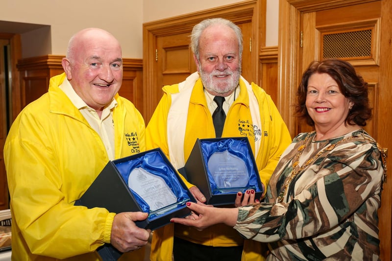 The Mayor of Derry and Strabane, Councillor Patricia Logue, presenting civic gifts to tour guides Garvin Kerr and John McNulty (Martin McCrossan City Tours) at a reception in the Guildhall. The Mayor hosted the reception to mark John’s 20th year as a local guide and Garvin’s retirement after 18 years. ©Lorcan Doherty