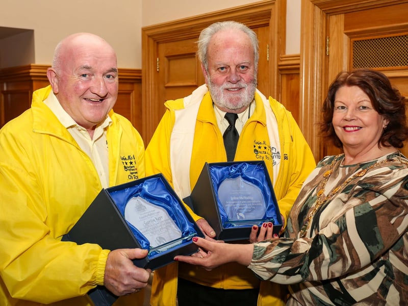 The Mayor of Derry and Strabane, Councillor Patricia Logue, presenting civic gifts to tour guides Garvin Kerr and John McNulty (Martin McCrossan City Tours) at a reception in the Guildhall. The Mayor hosted the reception to mark John’s 20th year as a local guide and Garvin’s retirement after 18 years. ©Lorcan Doherty