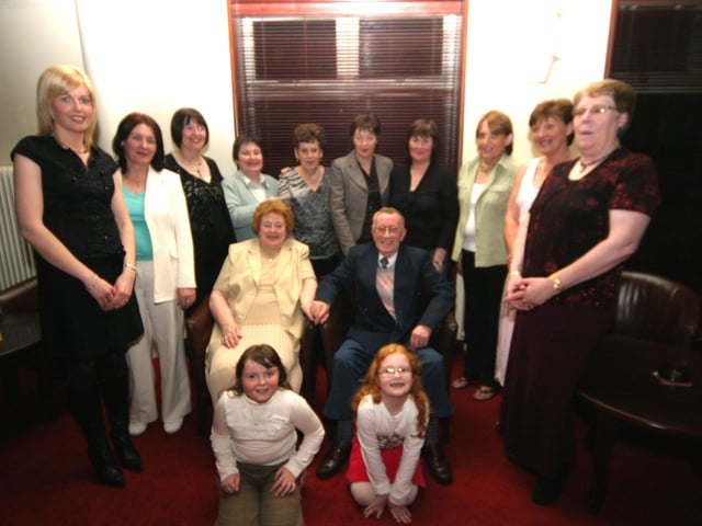 Posing for as photograph with Kathleen and Willie are, Catherine, Bernie, Patricia, Noreen, Margaret, Shiela, Donna, Jean, Helen, Mary, Bronagh and Caoimhe 0158JML : Parties and celebrations January 2006: Kathleen and Willie Quigley.