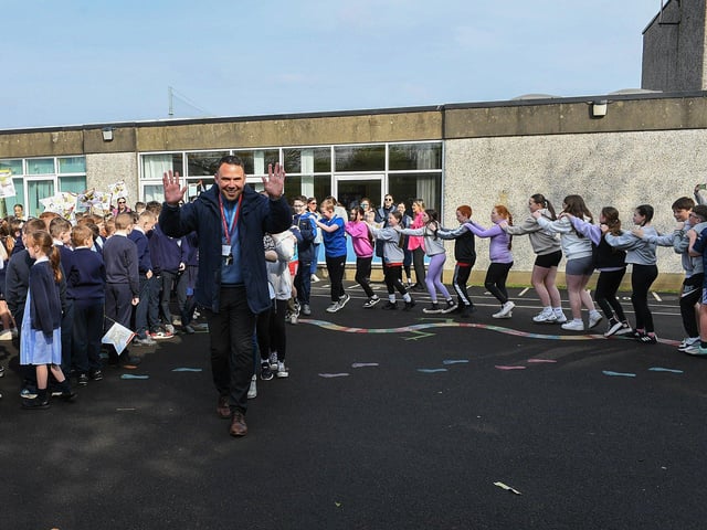 Mr Quinn leads the pupil’s chain during the Jive Aces performance at Rosemount Primary School on Thursday morning. Photo: George Sweeney