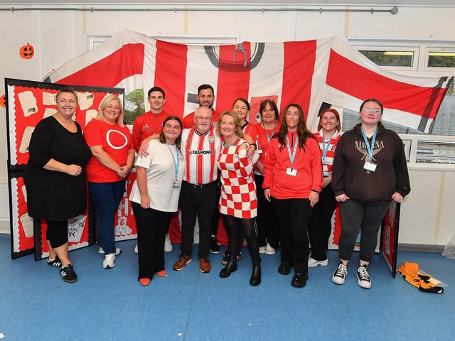 Staff from Gaelscoil Eadain Mhoir, pictured with Derry City’s Ciaran Coll and Pat Hoban during their visit to the school on Monday morning. Photo: George Sweeney