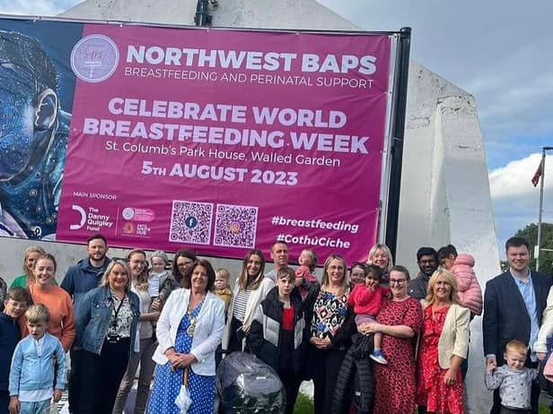 Members of North West BAPS with supporters and local politicians and community workers at the unveiling of a new banner at Free Derry Corner to mark World Breastfeeding Week.