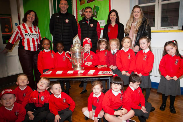 P1 pupils at St. Eugene’s PS show their support for Derry City on Monday last as players Shane McEleney and Joe Thompson brought the FAI Cup to the school.