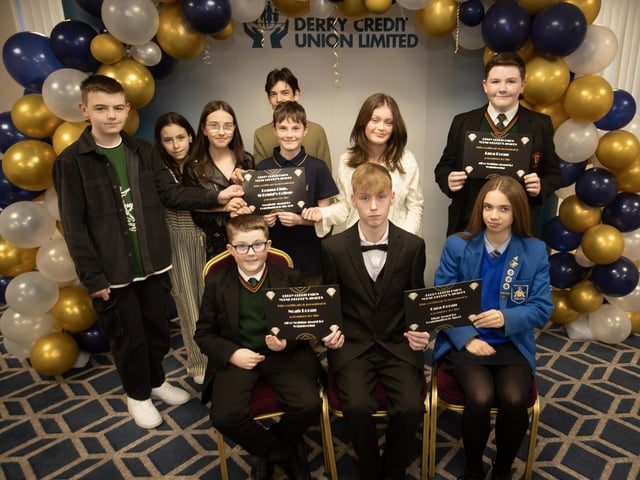 Derry Credit Union's Young People's Awards 2025 nominees being presented with their certificates by Ryan McLaughlin, Youth Committee, on Monday night. At front are Noah Doran and Cara Doran, and at back, members of the Drama Club from St. Brigid's College and Luca Doran.
