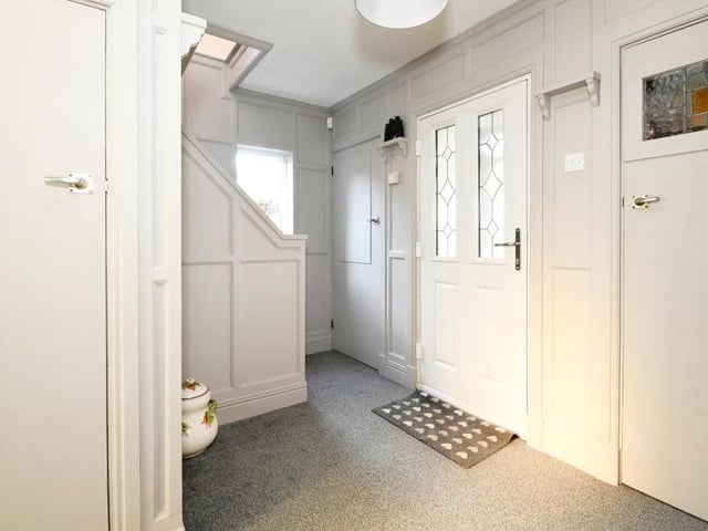 The entrance hall is welcoming, with its fitted carpet flooring, radiator, uPVC double-glazed window to the side and storage cupboard under the stairs.