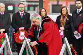 Alderman Darren Guy, as Deputy Mayor of Derry and Strabane District Council, laying a wreath at the war memorial last year. Photo: George Sweeney