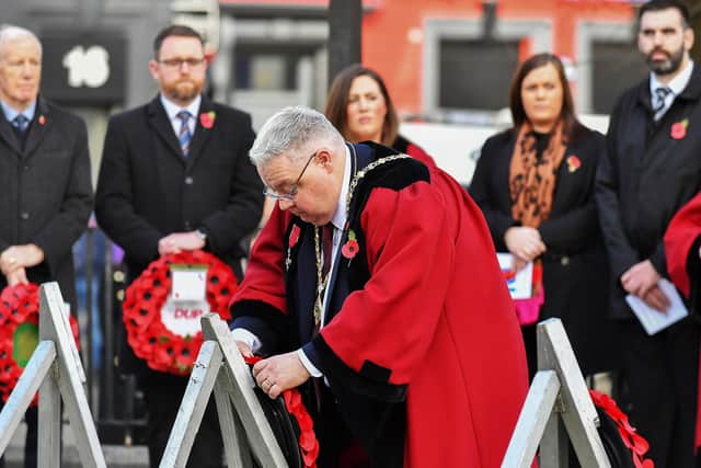 Alderman Darren Guy, as Deputy Mayor of Derry and Strabane District Council, laying a wreath at the war memorial last year. Photo: George Sweeney