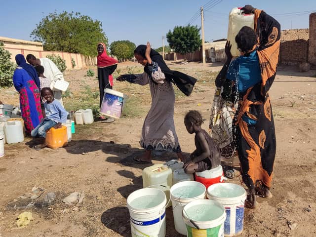 People fetch water in Al- Kamilin which was retaken by the Sudanese, in Sudan's al-Jazira state on February 19, 2025. Since it erupted in April 2023, the war between the army and Rapid Support Fprces paramilitaries has killed tens of thousands of people, forced over 12 million to flee their homes, and created "the biggest humanitarian crisis ever recorded" according to the International Rescue Committee. (Photo by AFP) (Photo by -/AFP via Getty Images)