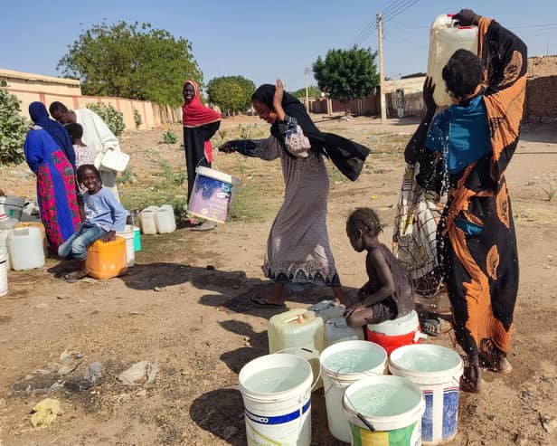 People fetch water in Al- Kamilin which was retaken by the Sudanese, in Sudan's al-Jazira state on February 19, 2025. Since it erupted in April 2023, the war between the army and Rapid Support Fprces paramilitaries has killed tens of thousands of people, forced over 12 million to flee their homes, and created "the biggest humanitarian crisis ever recorded" according to the International Rescue Committee. (Photo by AFP) (Photo by -/AFP via Getty Images)
