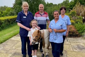 Little Star with staff with visitors at the Foyle Hospice.