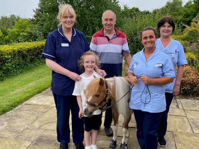 Little Star with staff with visitors at the Foyle Hospice.