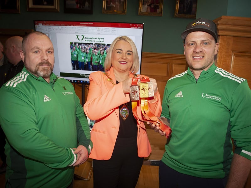The Mayor Sandra Duffy showing some of the medals won by Richie Sheerin, Transplant Sport Northern Ireland, during Thursday’s event to promote this year’s event at the Guildhall. On right is Kevin Bell, organiser.