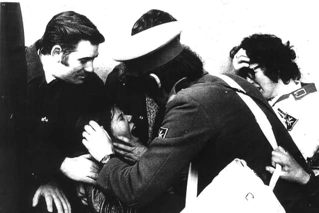 Paul McLaughlin and Antoinette Coyle shelter at the end of Rossville Flats. Photo Fulvio Grimaldi (via Museum of Free Derry)