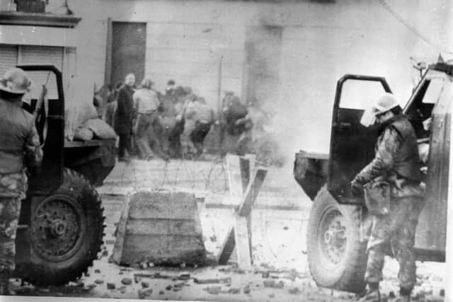 File photo dated 30/01/72 of soldiers taking cover behind their sandbagged armoured cars while dispersing rioters with CS gas in Londonderry. A judge will rule later on whether to admit "decisive" evidence to the trial of a former paratrooper accused of two murders on Bloody Sunday. Issue date: Wednesday September 24, 2025.