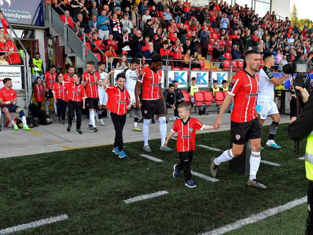 Derry City players and mascots at the game against Sligo Rovers in the Brandywell on Friday evening. Photo: George Sweeney. DER2327GS - 082