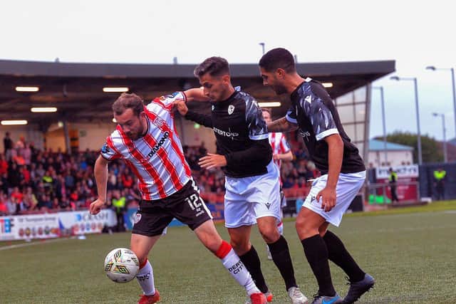 Derry City‘s Paul McMullan holds off FCB Magpies pair Juan Arguez and Carlos Garcia. Photograph: George Sweeney
