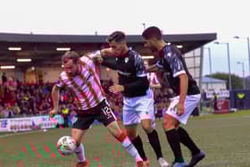 Derry City‘s Paul McMullan holds off FCB Magpies pair Juan Arguez and Carlos Garcia. Photograph: George Sweeney