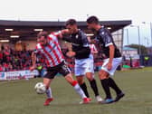 Derry City‘s Paul McMullan holds off FCB Magpies pair Juan Arguez and Carlos Garcia. Photograph: George Sweeney