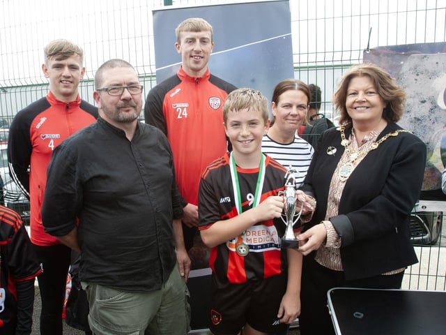 Mayor of Derry CIty & Strabane District Council Patricia Logue makes a presentation to winning Phoenix captain, Harrison Moore.