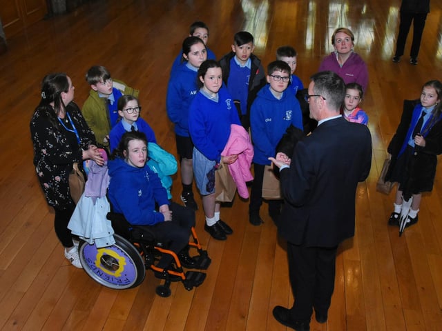 Nazareth House PS School Council pictured getting a tour of the Guildhall with DCSDC's Chris Walker.