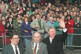 November 30, 1995 Derry:  US President Bill Clinton waves at the crowd after a walk in Derry with John Hume and then Mayor John Kerr. (LUKE FRAZZA/AFP via Getty Images)