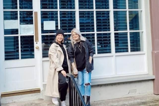 Chloe Mc Colgan, owner of In_Chlomo, and Bridgene Graham, owner of Coalesce, collecting the keys to their new boutique In_Co on Shipquay Street.