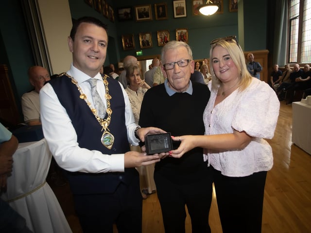 The Mayor, Ruari McHugh and Councillor Sandra Duffy make a special presentation to Eamon Wilkinson, long-serving referee of the Eamonn 'Bronco' Bradley Football Tournament, during a reception in the Guildhall on Friday evening to mark the tournament's 40th anniversary. (Photos: Jim McCafferty Photography)